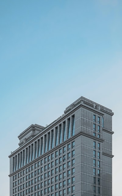 Grey multiple shop building under the blue sky
